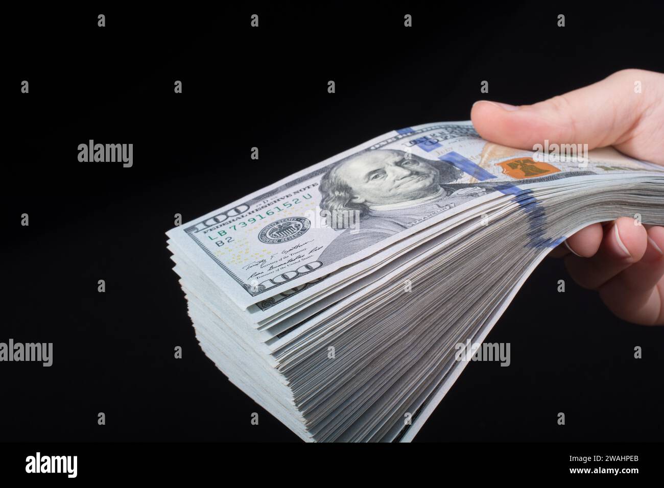Hand holding American dollar banknotes isolated on white background ...