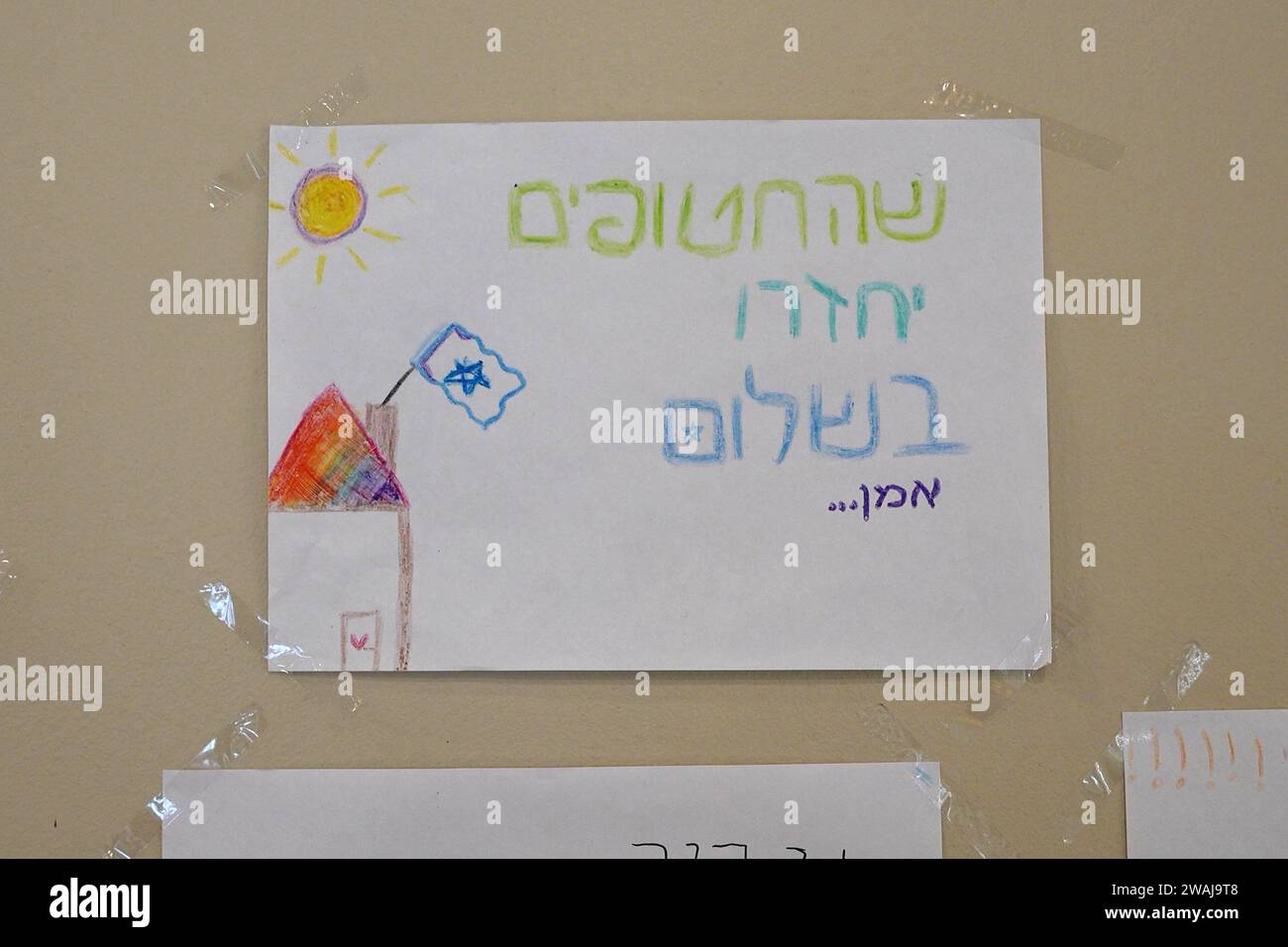 Paper with message of hope for the return of Israeli captives in Gaza drawn by children of residents who were evacuated from communities near the border with Lebanon hangs in a wall at a temporary classroom in Kibbutz HaOn where many residents of communities were evacuated to since the cross-border fire began after the October 7 attacks by Palestinian militants from the Gaza Strip on January 4, 2023 in Kibbutz HaOn, Israel. Stock Photo