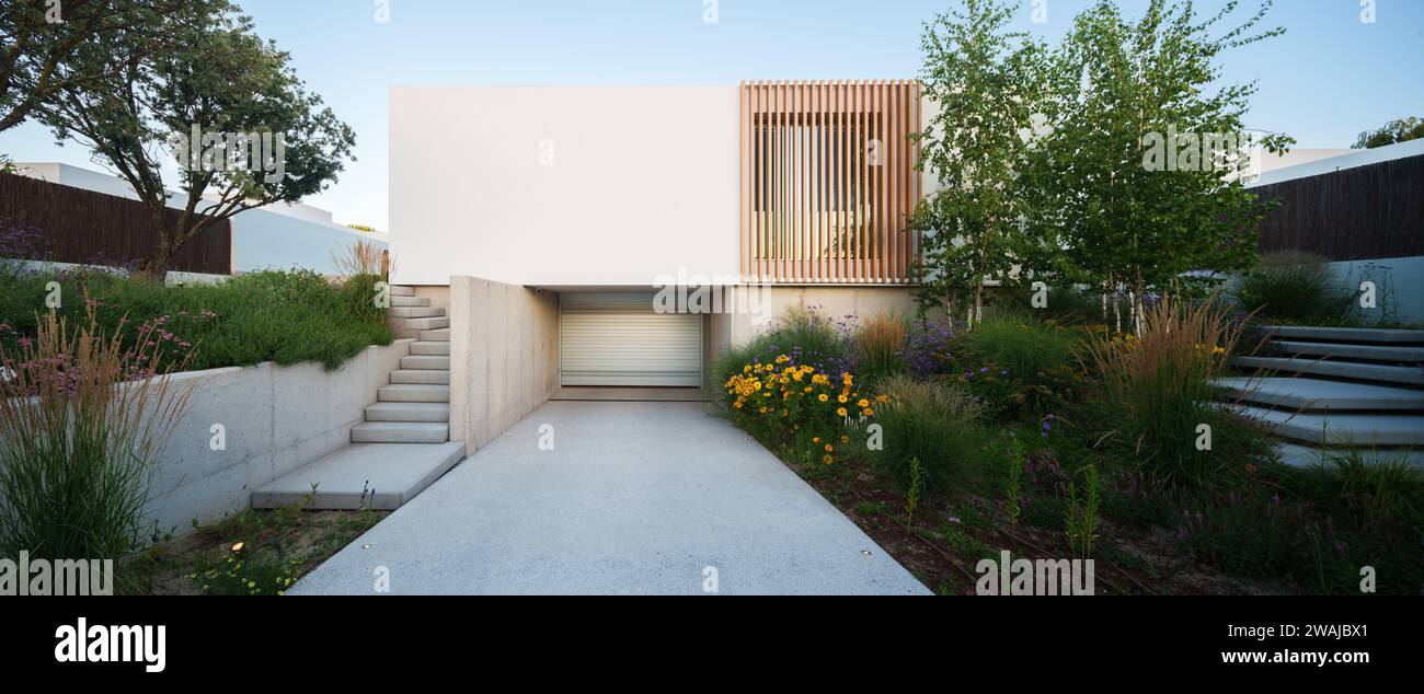 Timber Slat Path Contemporary sustainable house facade with concrete stairs and ...
