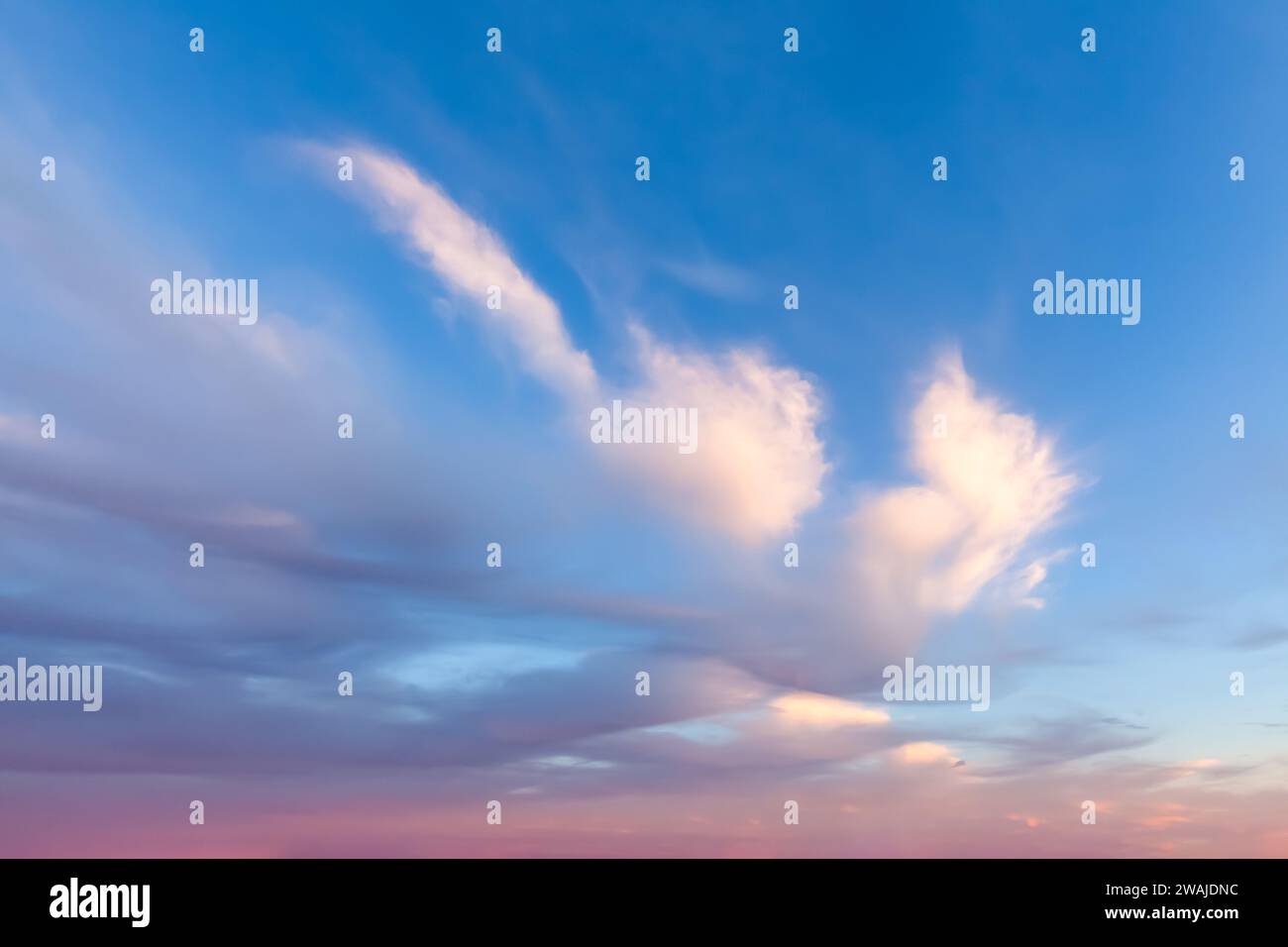Beautiful wispy clouds with pink and blue background Stock Photo - Alamy
