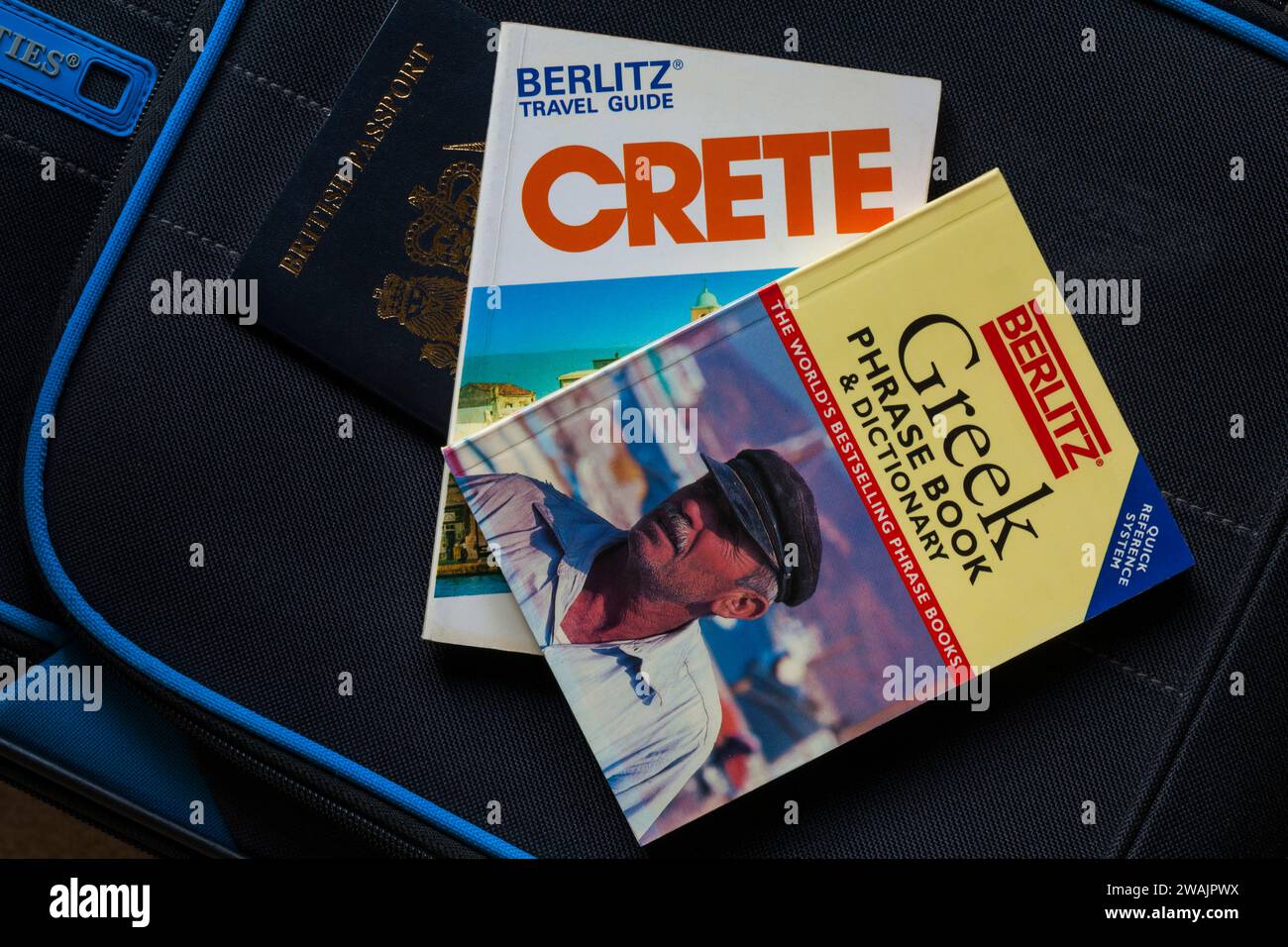 Crete Berlitz Travel Guide book Greek phrase book & dictionary with British passport on suitcase
