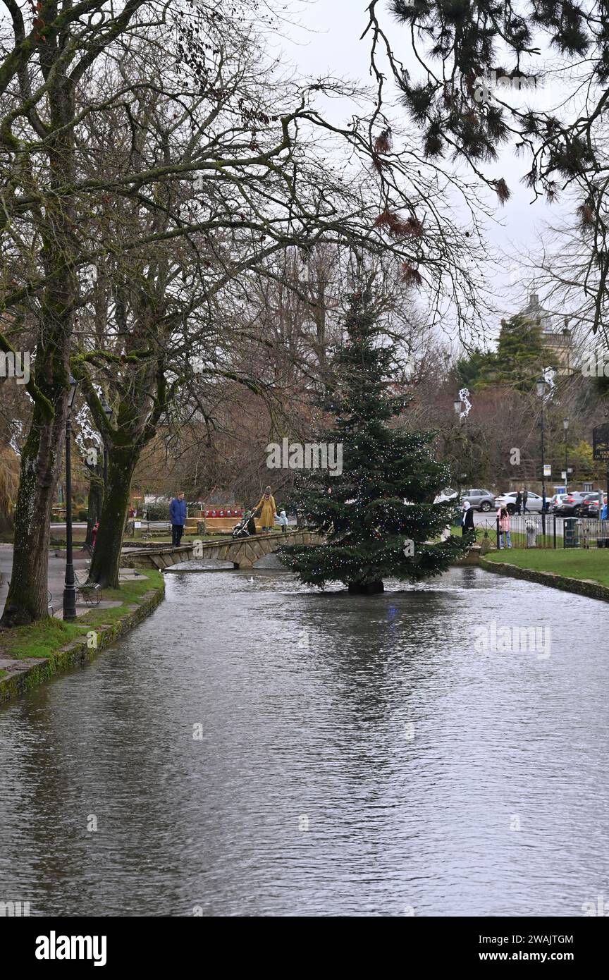 The Christmas tree in the Cotswold village of Bourton on the Water stands in the middle of the