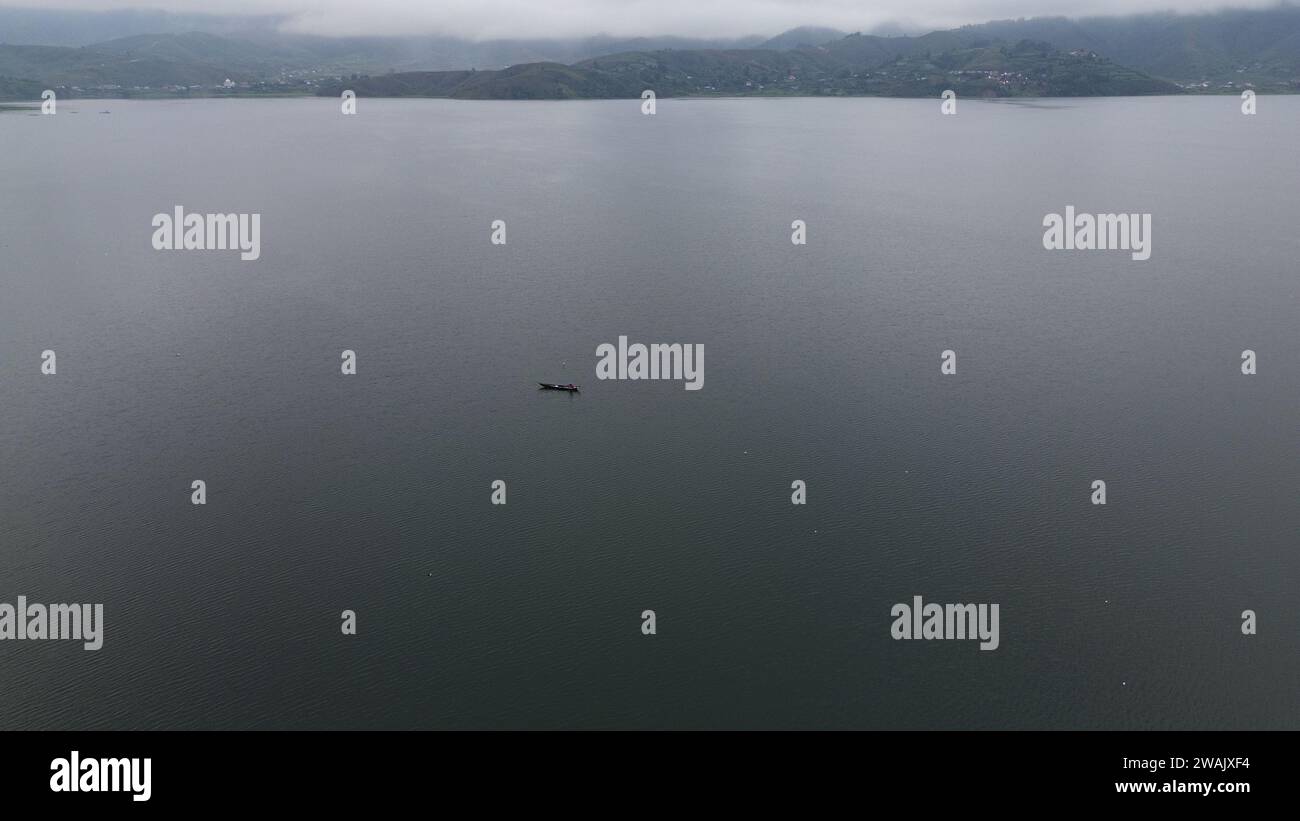 Capture the serene beauty of a stunning aerial view of a pristine lake ...