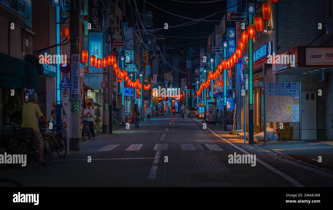 Street in tokyo filled with colorful lights at night Stock Photo