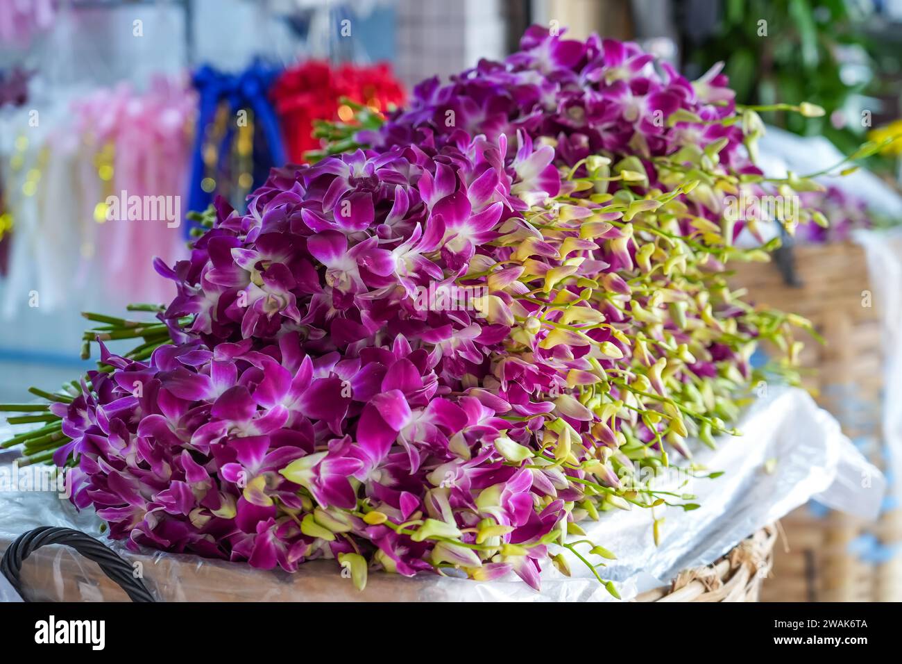 Fresh purple magenta pink Mokara orchid flower bouquet cut sale market Stock Photo