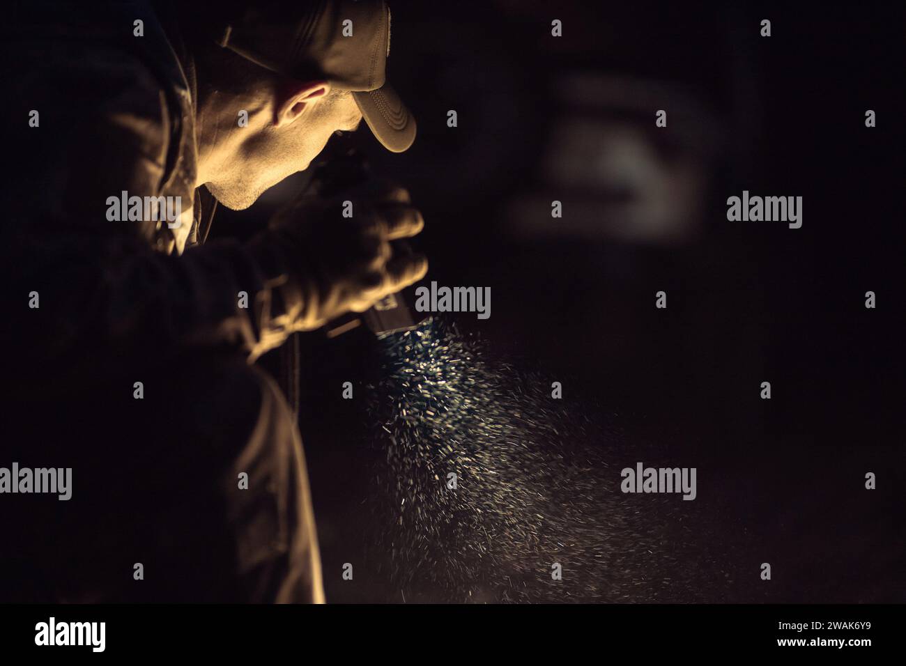 A Man with a Flashlight in His Hand During Night Time Hours Looking For Something. Stock Photo