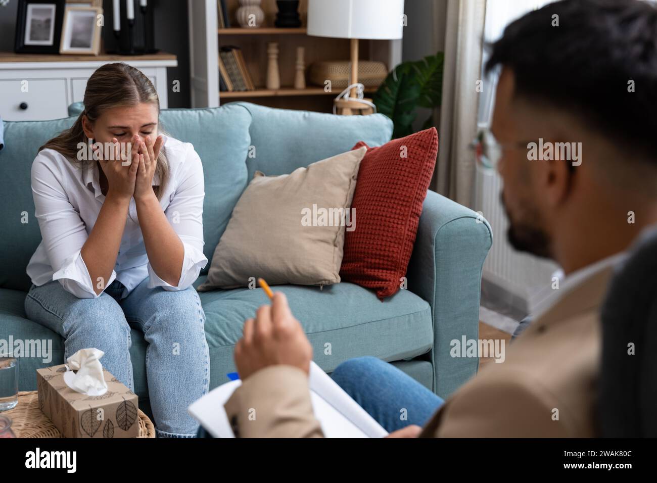 Young businesswoman undergoing psychotherapy after loss of her job bankruptcy of private company or the death of a close family member. Woman seeks he Stock Photo