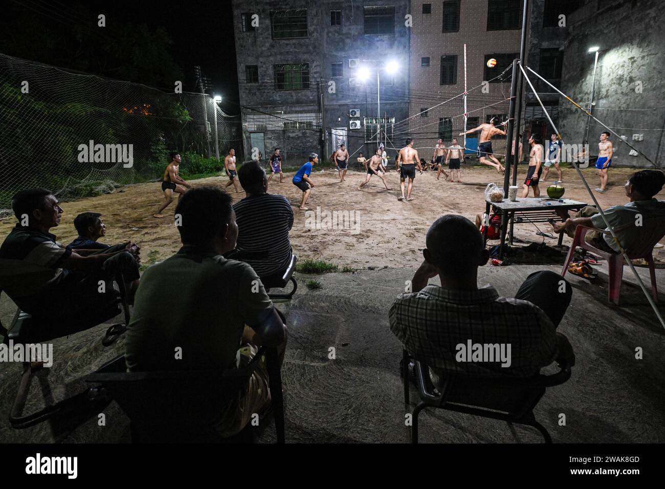 Beijing, China's Hainan Province. 18th July, 2023. People watch a beach volleyball match at Dongge Town in Wenchang, south China's Hainan Province, July 18, 2023. Wenchang, known as the 'city of volleyball,' has a thriving volleyball culture and a huge fanbase for the sport. The city with a population of 600,000 now houses nearly 600 volleyball courts and at least one court in every village. Credit: Pu Xiaoxu/Xinhua/Alamy Live News Stock Photo