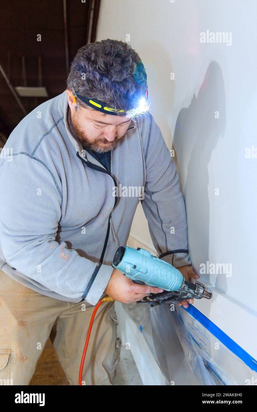 When contractor is installing wooden trim moldings in room, he uses an