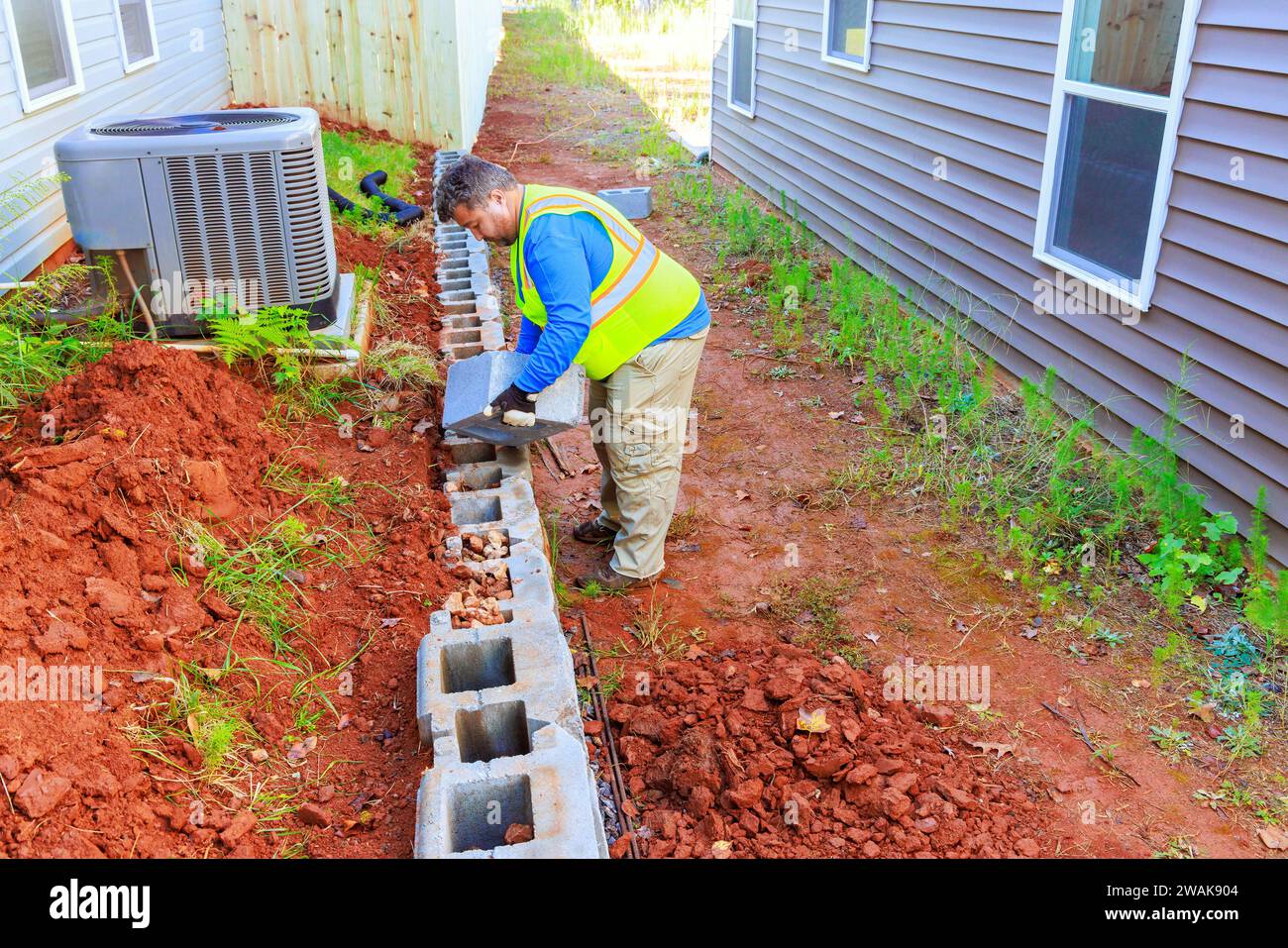 Constructing retaining walls that are being installed by contractor Stock Photo