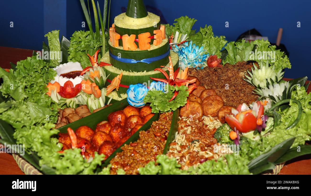 Rice in a cone shape or called Nasi Tumpeng A festive Indonesian rice dish with side dishes Stock Photo