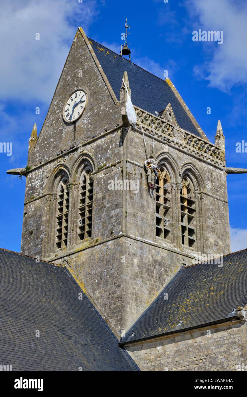 France, Manche, Sainte Mère-Eglise, mannequin of paratrooper John Steele hanging from the church tower Stock Photo