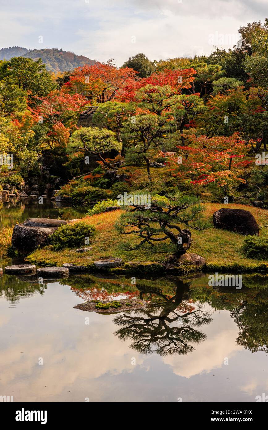 isuien traditional japanese garden in nara with autumn trees reflected in the pond and borrowed scenery of mountains behind Stock Photo