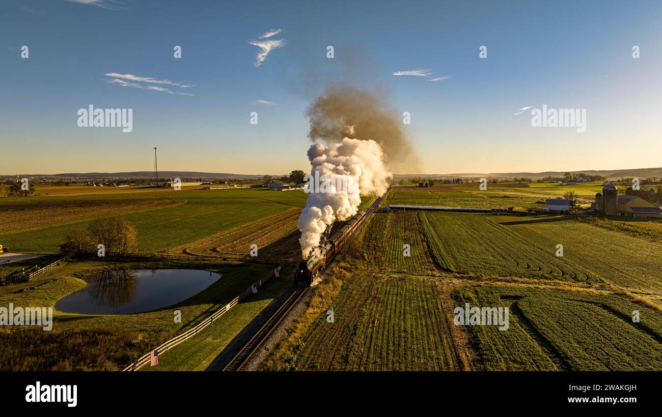 A vintage steam locomotive on a journey through a peaceful countryside ...