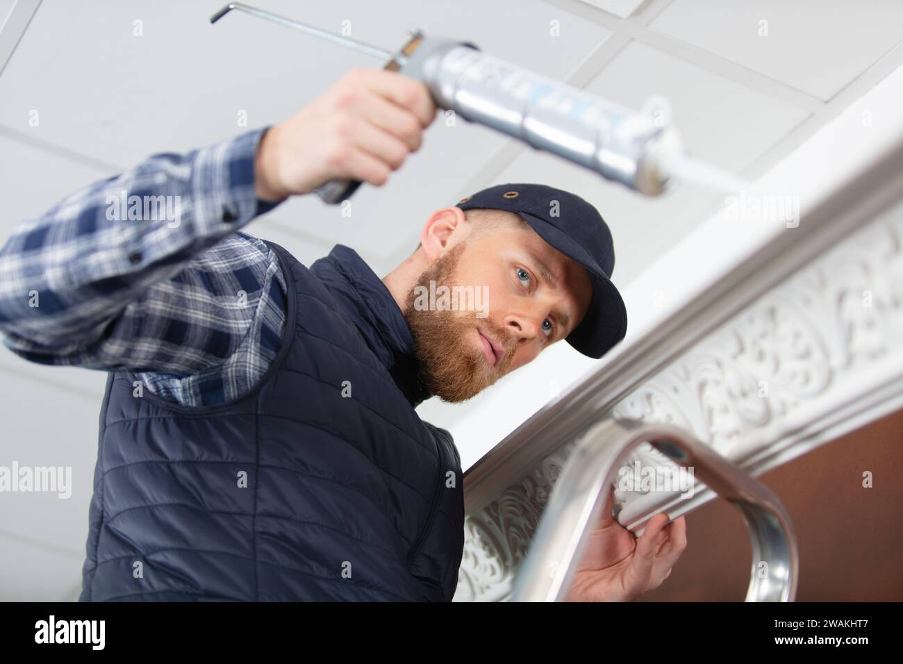 man applying silicone sealant with caulking gun Stock Photo Alamy