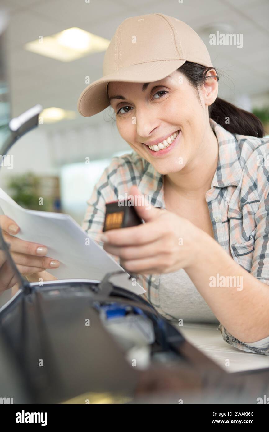 a woman on printer maintenance Stock Photo