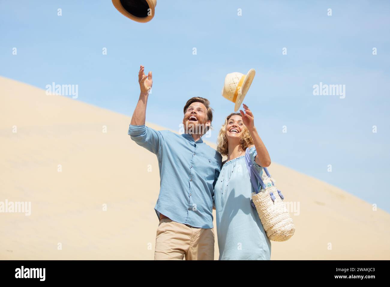 happy couple throwing hats in the air Stock Photo Alamy