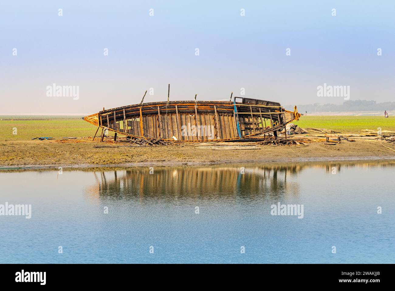 Repairing a wooden boat on the riverbank in Bangladesh Stock Photo - Alamy