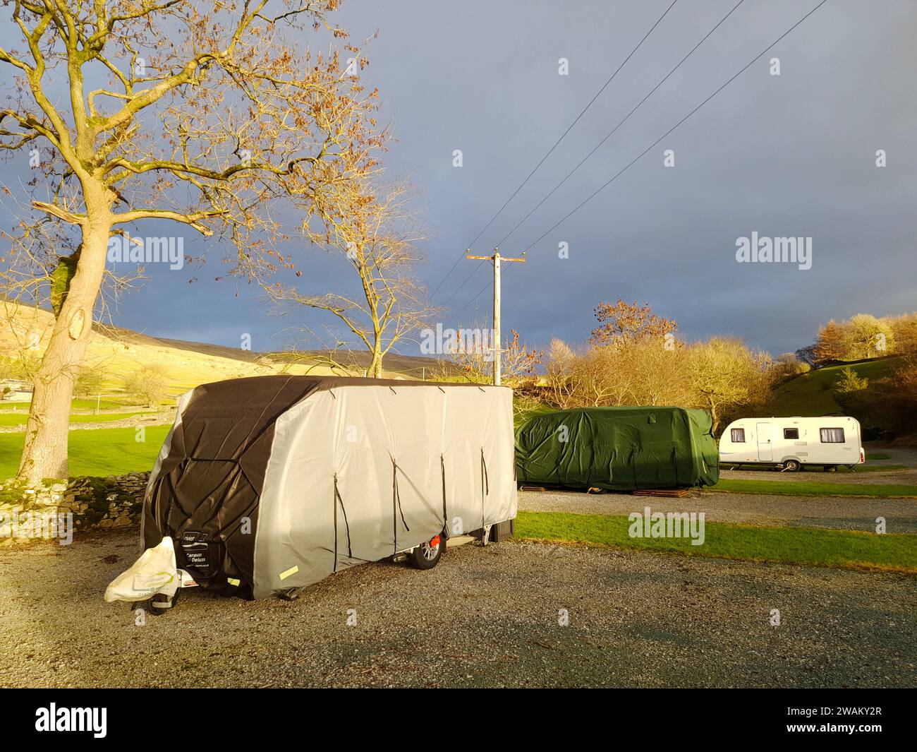 Caravans on a famrm site covered for the winter in Austwick, Yorkshire Dales, UK. Stock Photo