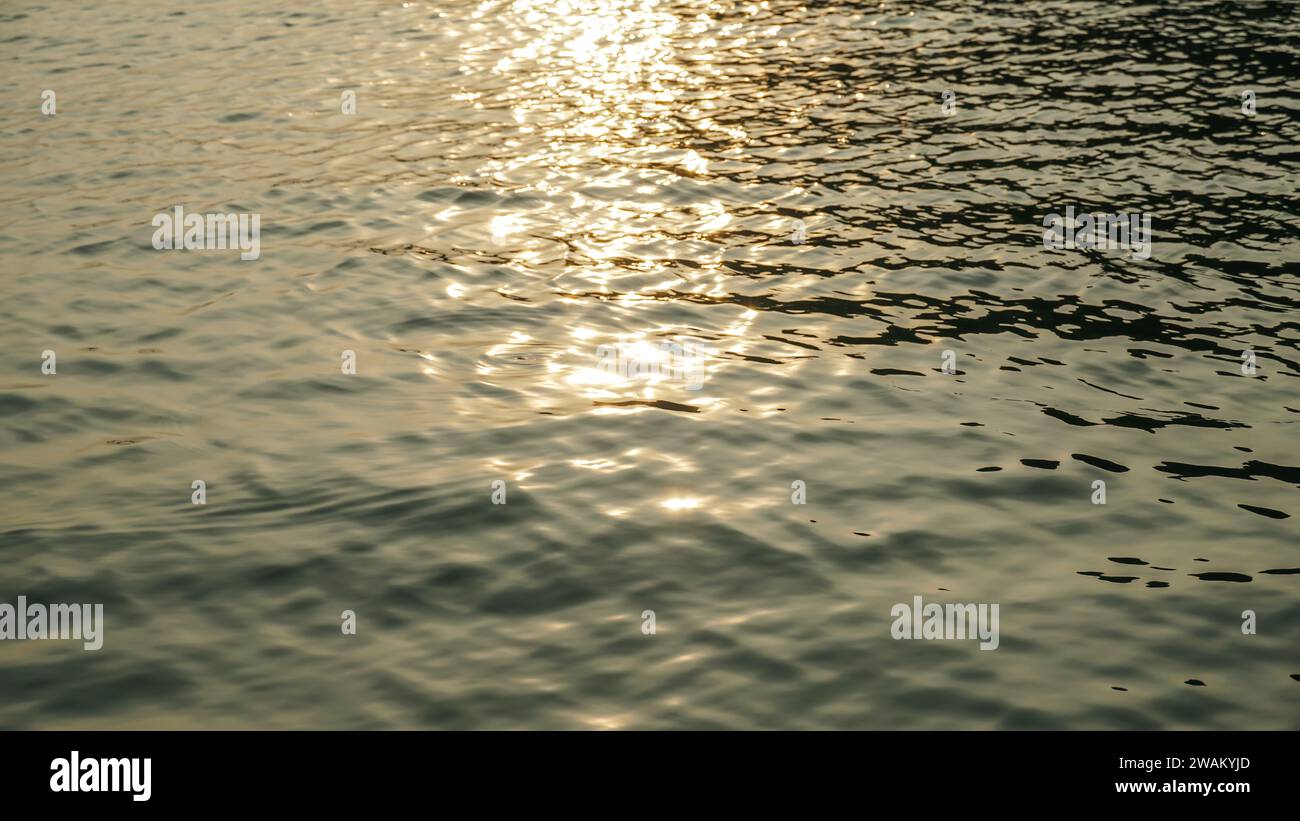 Beautiful close up sea water surface. Close-up of golden water with ...