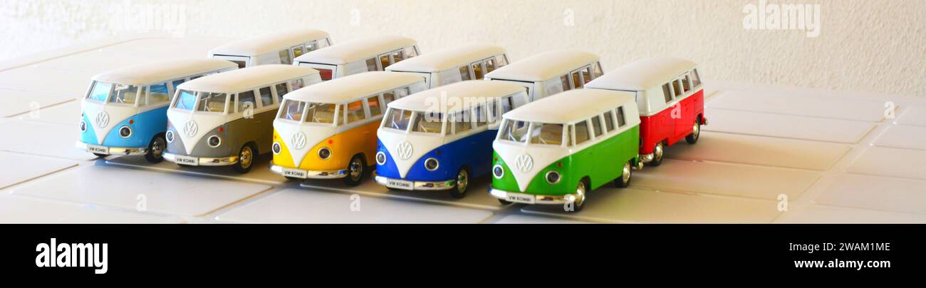 Diecast, Iron miniature, Vans of various colors, Brazil, South America, top view, selective focus on white table on white background, copy space Stock Photo