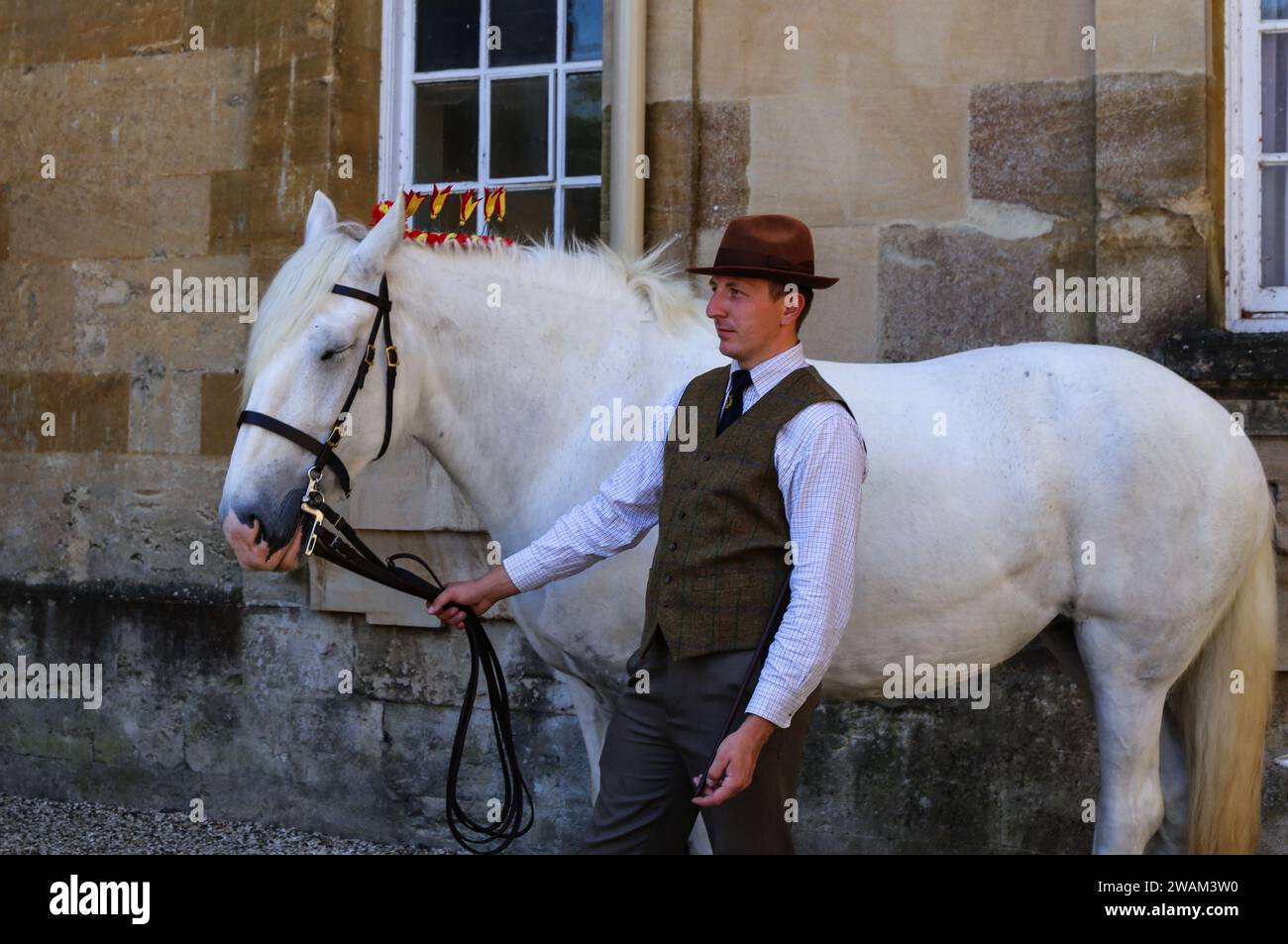 Groom holding the reins of a horse at Blenheim Palace Woodstock