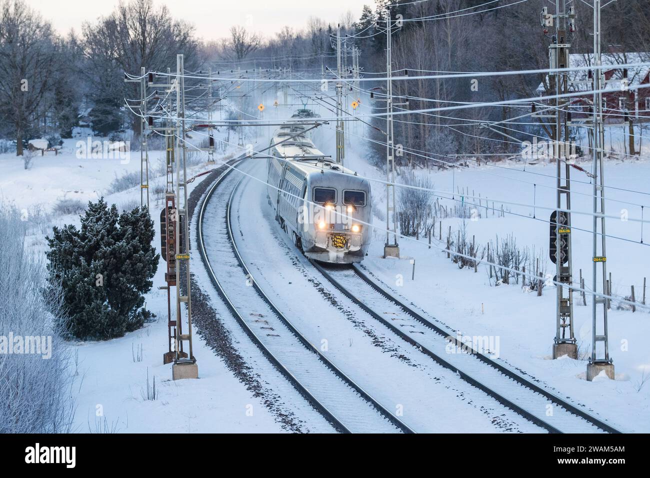 Seasonal weather, a X2000 train from SJ, just south Mjölby, Sweden, during Friday afternoon. Stock Photo