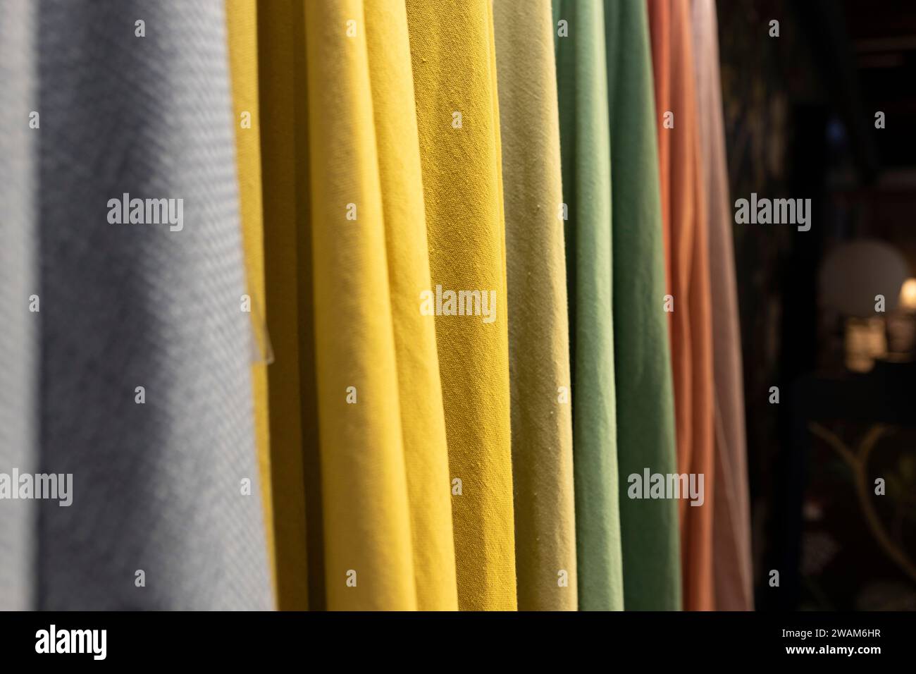 Various wool and silk fabrics are on display at the shop Stock Photo