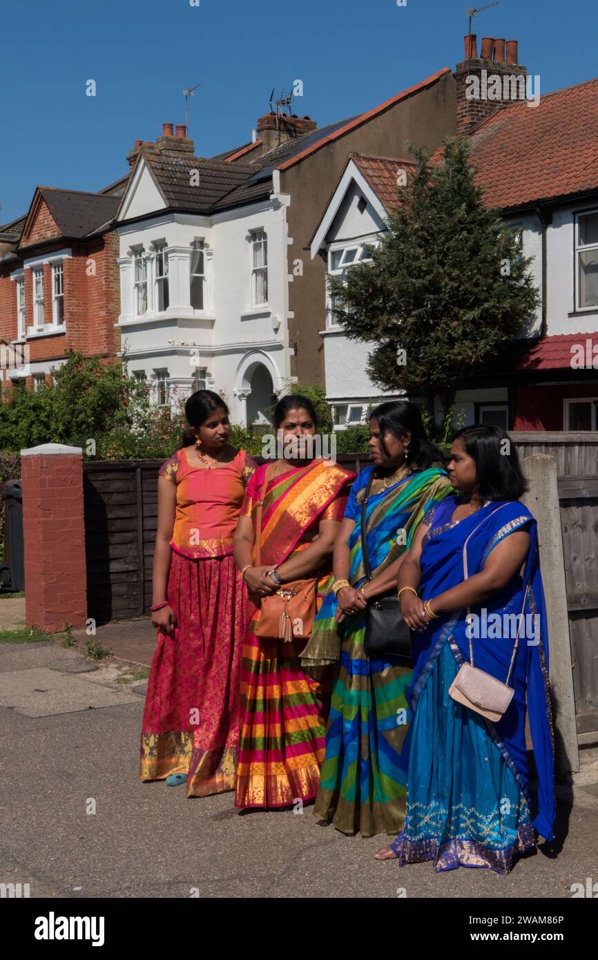British Hindu UK women in traditional dress attend the Hindu Ratha Yatra Rathayatra or Chariot festival at the Shree Ghanapathy Temple in suburban Wimbledon. South London England 7th August 2022 UK HOMER SYKES Stock Photo
