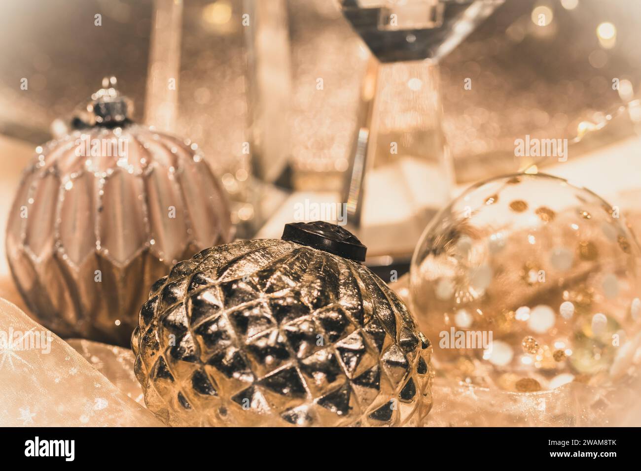 Close-up of Christmas baubles on a table decorated for Christmas, warm gold colors Stock Photo