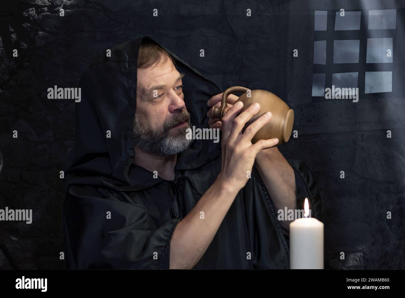 Elderly monk in black cloak hi-res stock photography and images - Alamy