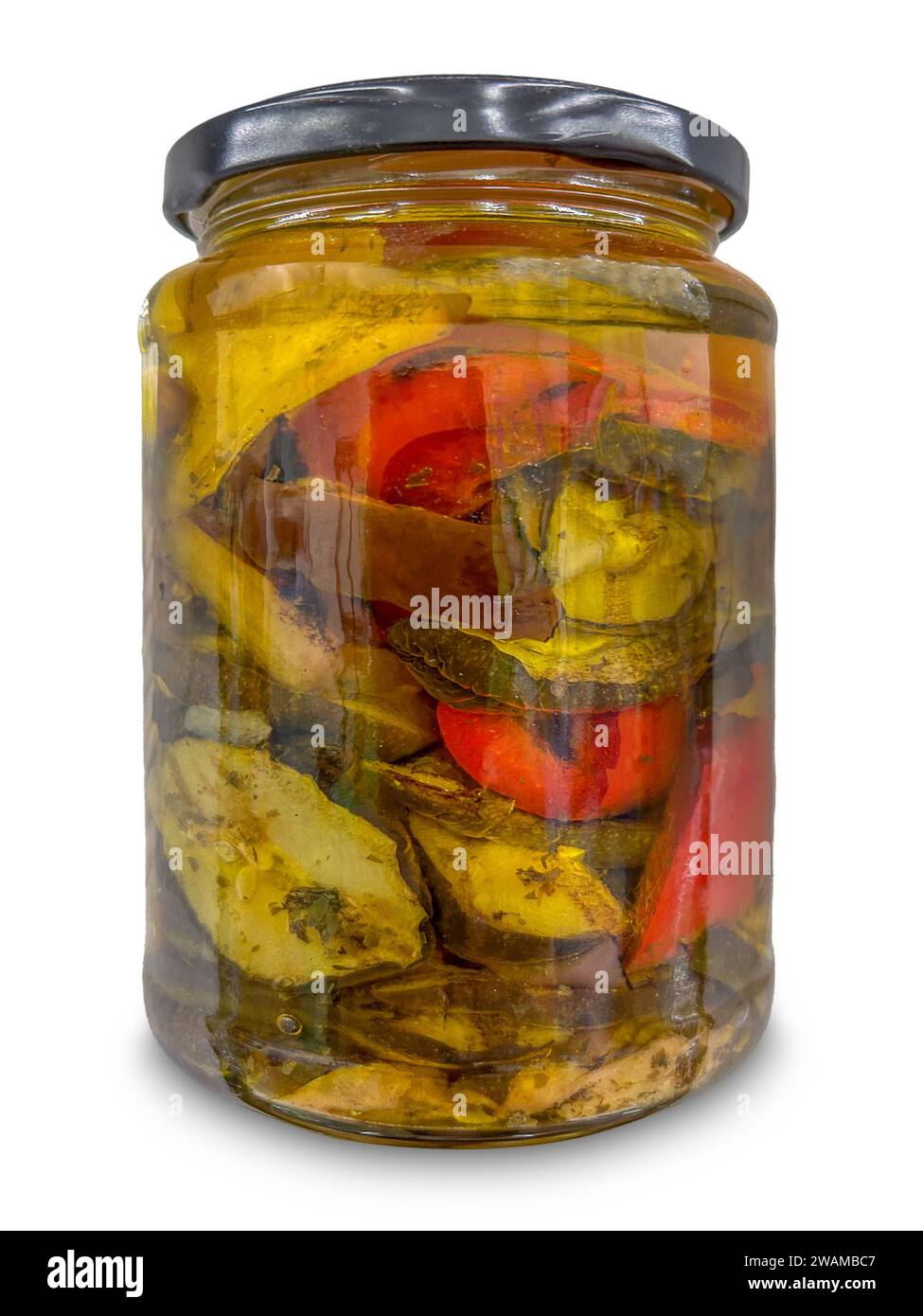 Mixed vegetables grilled and preserved in oil in glass jar isolated on