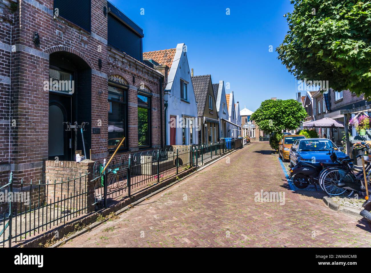 Lemmer, Netherlands - August 12, 2022: Street with small houses in the city of Lemmer in Friesland, Netherlands on a sunny summer afternoon Stock Photo