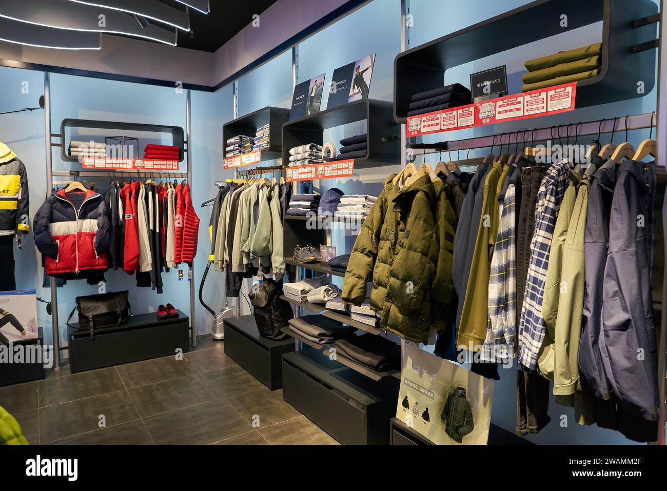 SHENZHEN, CHINA - NOVEMBER 21, 2019: apparel on display at store inside ...