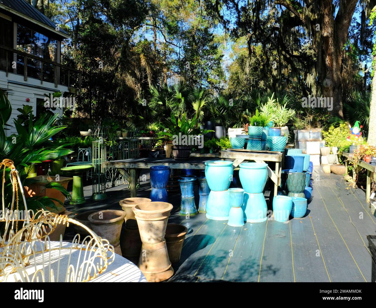 Clay and ceramic pots and pottery for sale at a nursery's outdoor patio deck; gardening supplies. Stock Photo