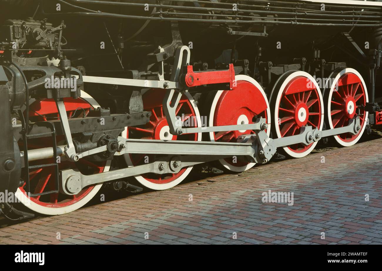Wheels of the old black steam locomotive of Soviet times. The side of ...