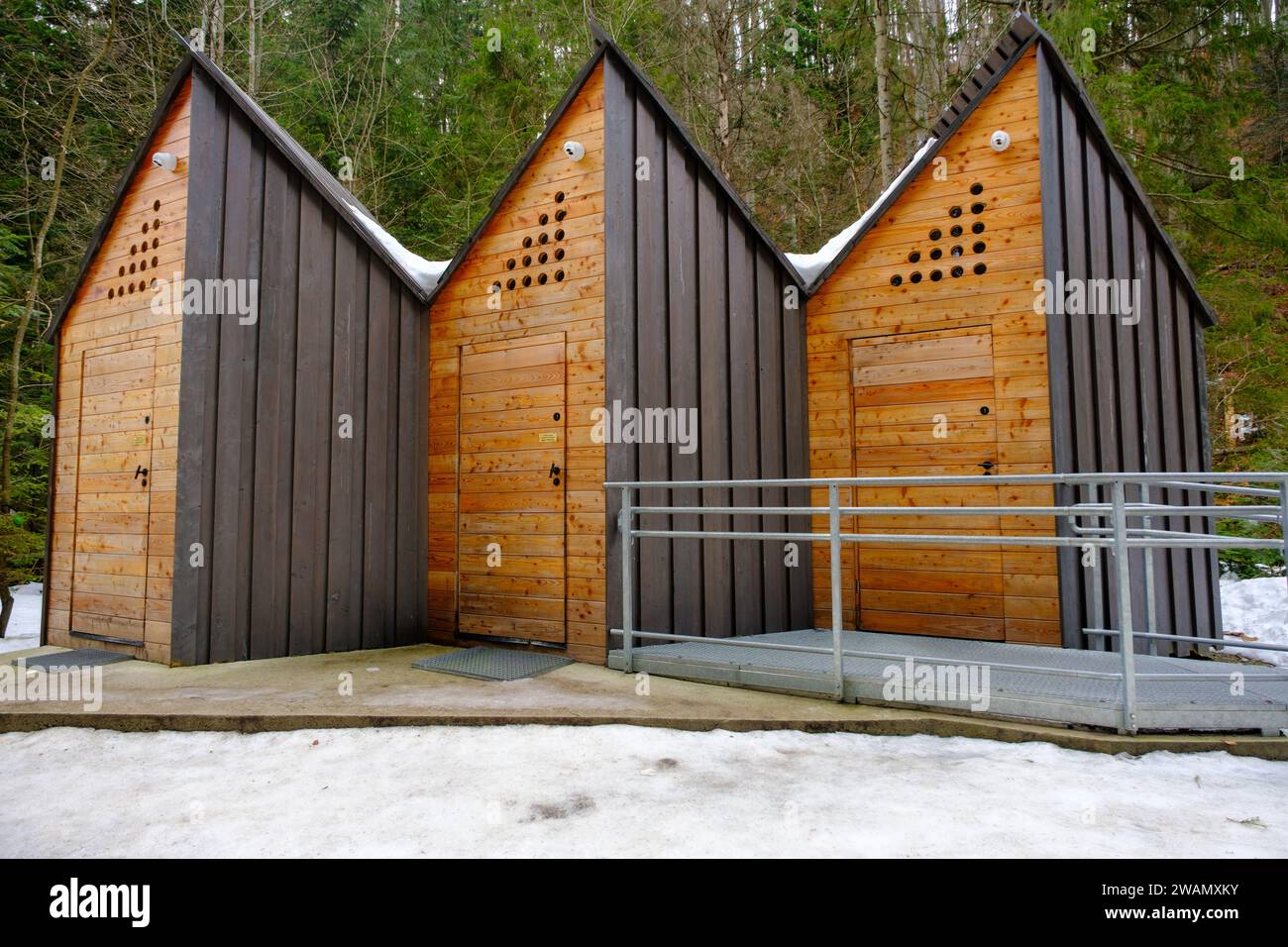 wooden public toilets in the forest along the tourist trail route. Stock Photo