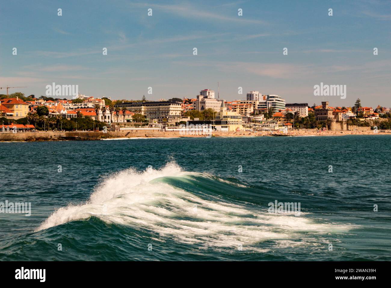 Ocean waves and the city of Estoril Portugal in the background Stock Photo