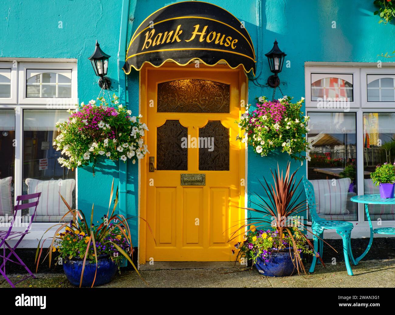 The turquoise face and yellow door of the Bank House B&B in Sneem