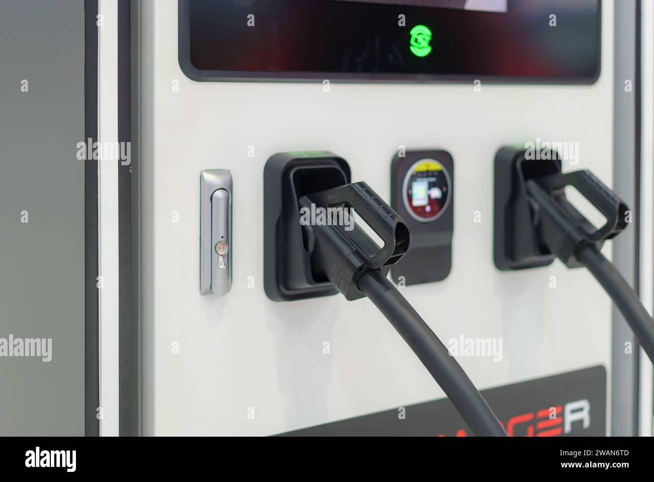 Fast EV chargers in a park setting charging stations stand ready to power electric vehicles swiftly, symbolizing the seamless integration of cutting-e Stock Photo