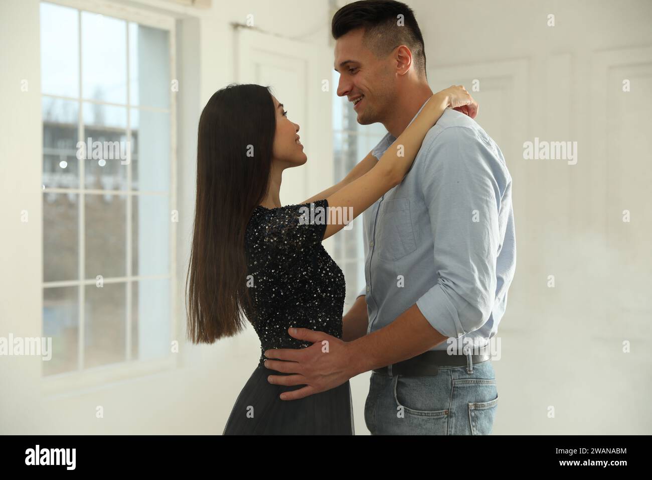 Lovely young couple dancing together in ballroom Stock Photo