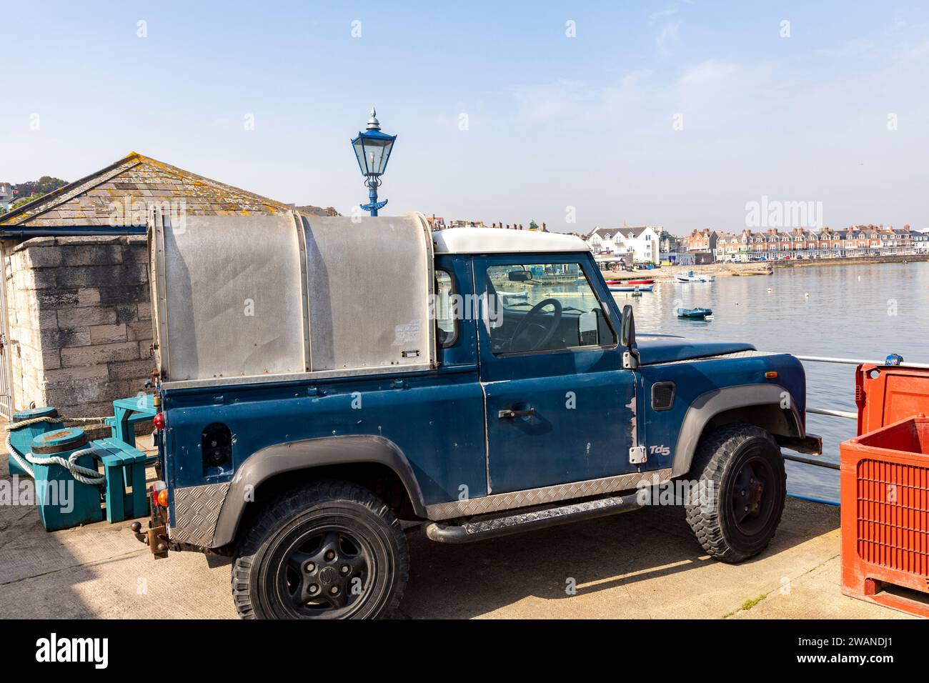 Land Rover Defender 90 td5 classic vehicle in blue with canopy and white roof parked on Swanage Pier, Dorset,England,2023 Stock Photo
