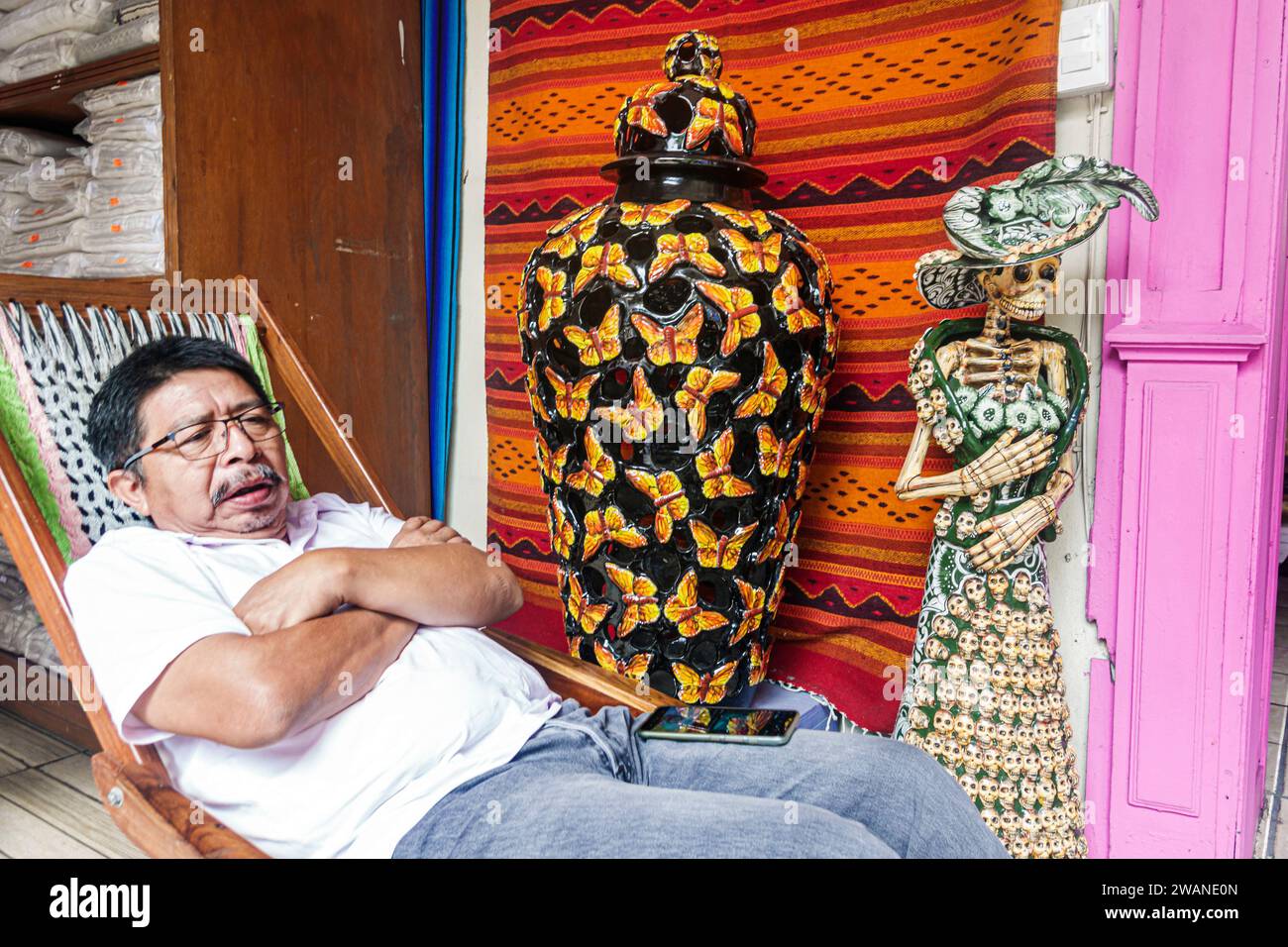 Merida Mexico,centro historico central historic district,resting relaxing chair,La Catrina Day of Dead skeleton,large vase,art collective gallery Maya Stock Photo