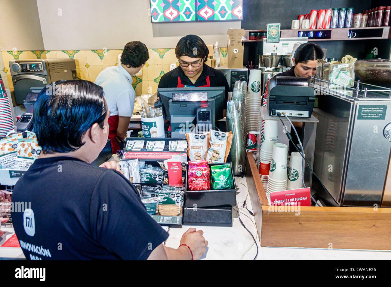 Merida Mexico,centro historico central historic district,Starbucks Coffee cafe baristas,man men male,adult,resident,inside interior indoors,employee w Stock Photo