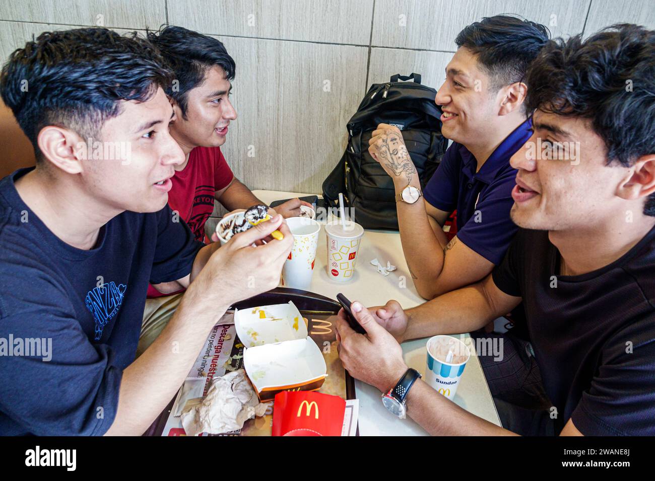 Merida Mexico,centro historico central historic district,McDonald's fast food,eating talking,teen teenage teenager,youth culture adolescent,resident b Stock Photo