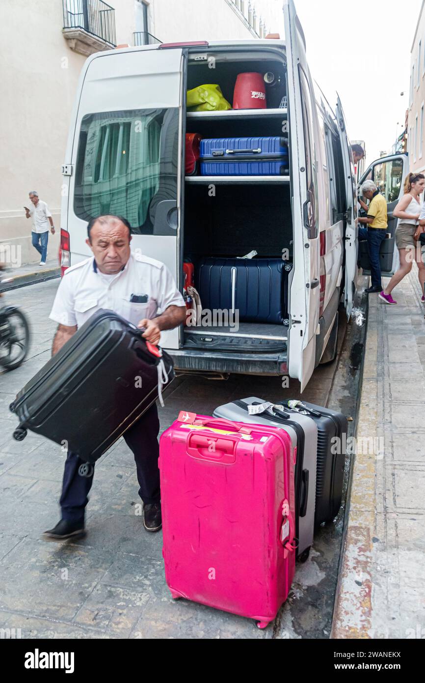 Merida Mexico,centro historico central historic district,airport shuttle van,delivering luggage unloading suitcases baggage,man men male,adult,residen Stock Photo