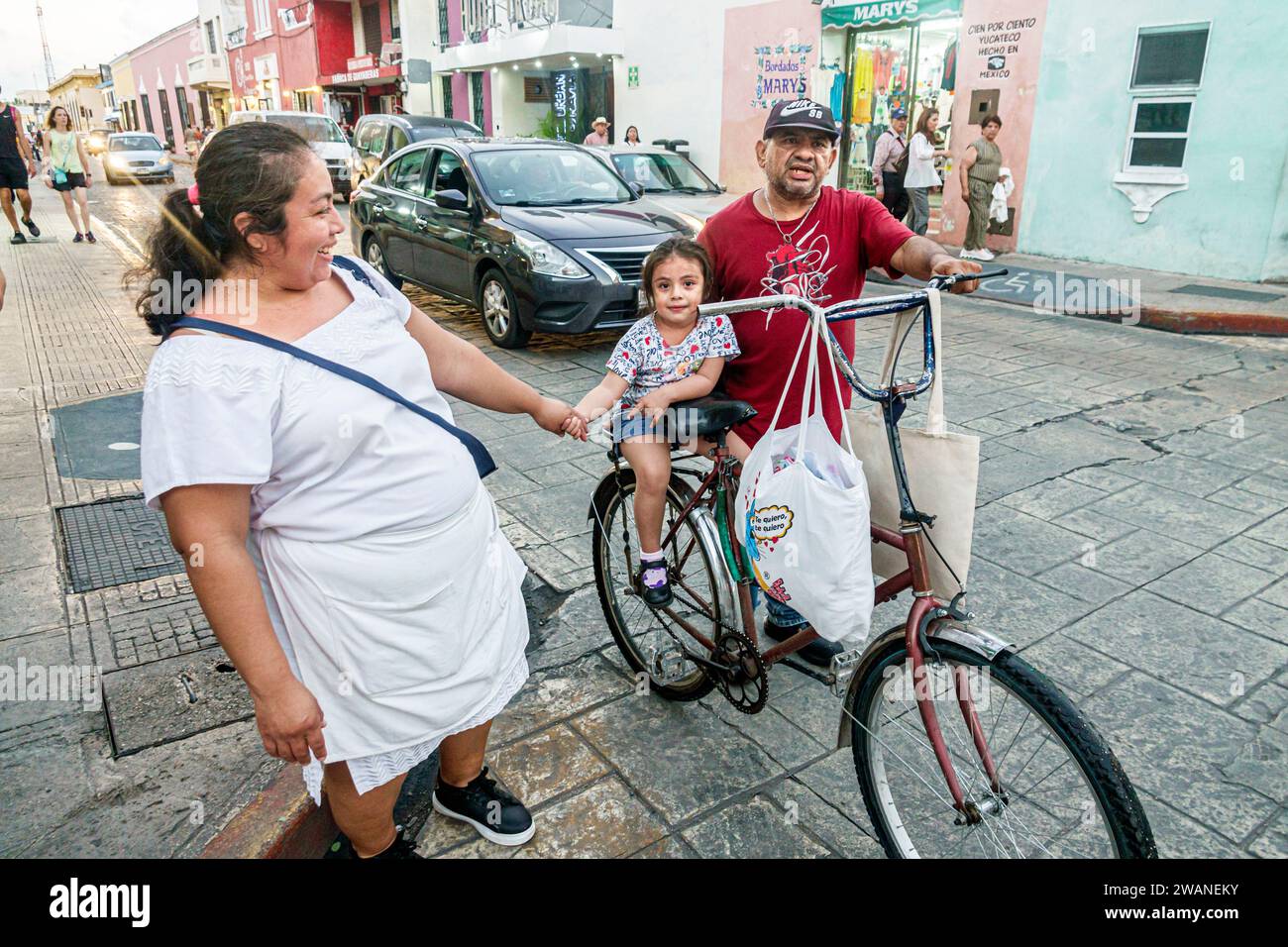 Merida Mexico,centro historico central historic district,bicycle holding hands,man men male,woman women lady female,adults residents couple,family par Stock Photo