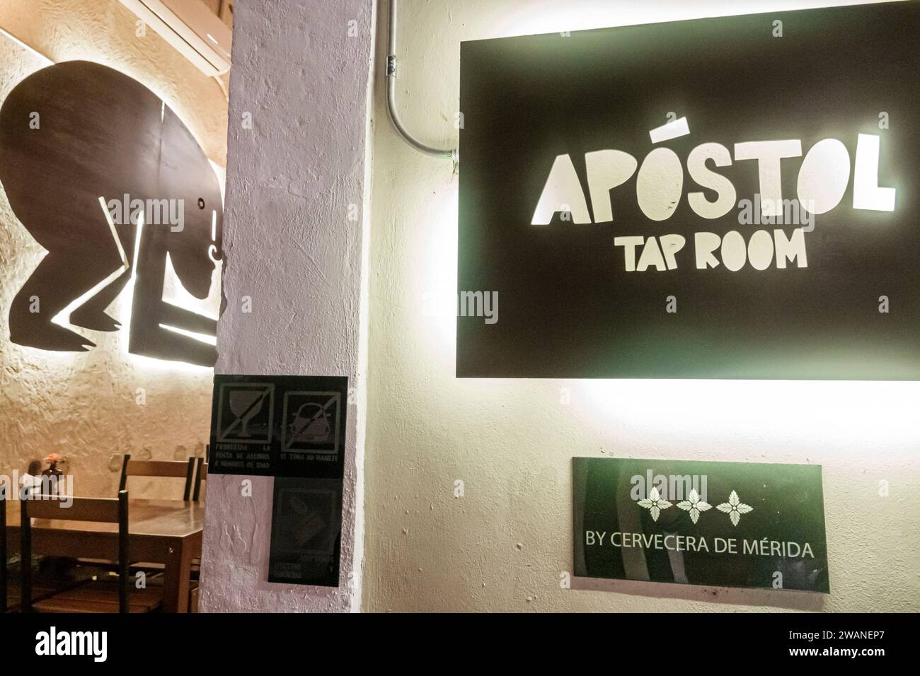 Merida Mexico,centro historico central historic district,Apostol Tap Room chairs tables,bar pub,inside interior indoors,sign signs information,promoti Stock Photo