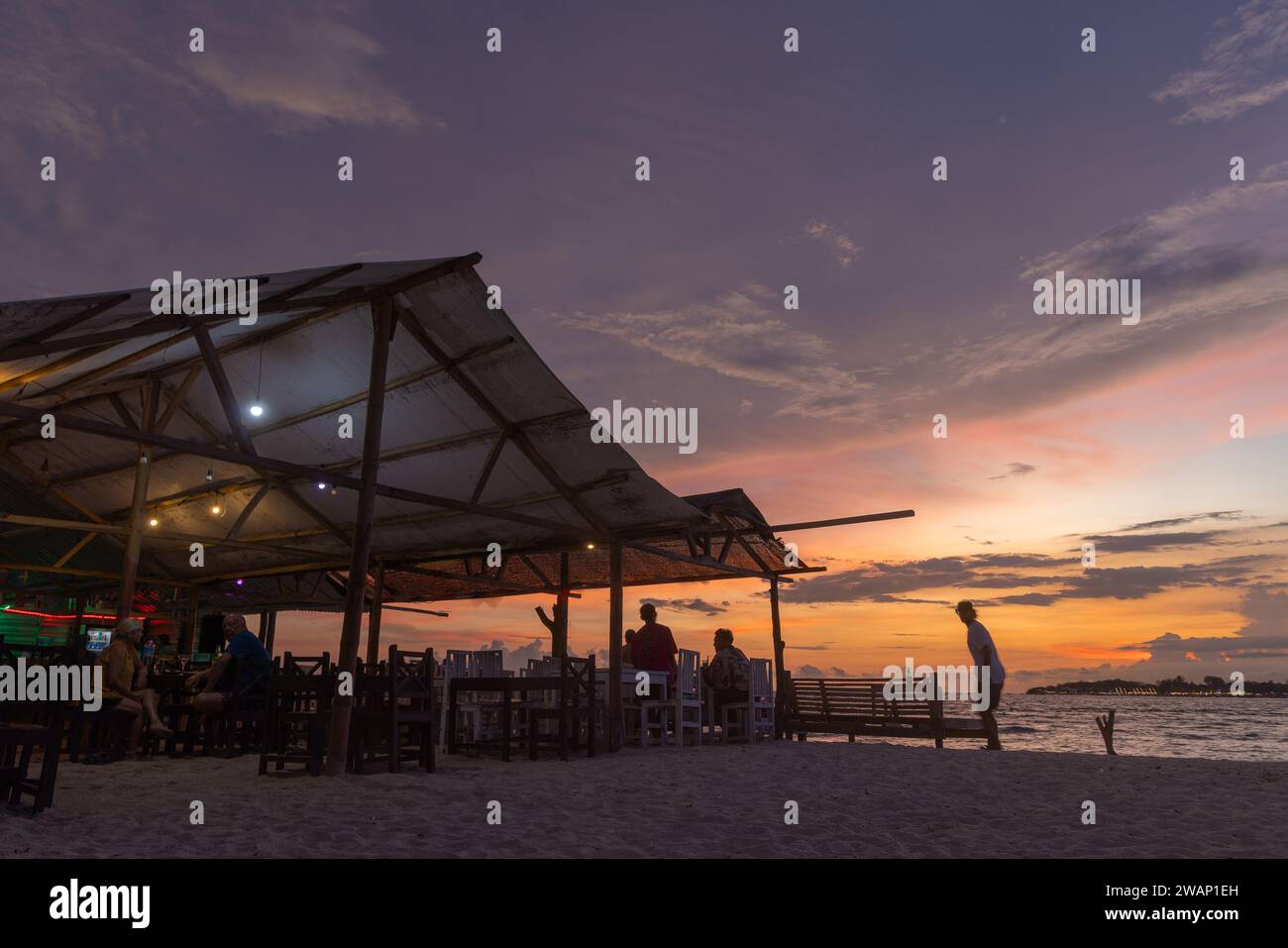 Beach restaurant at dusk on Gili Meno, Indonesia Stock Photo