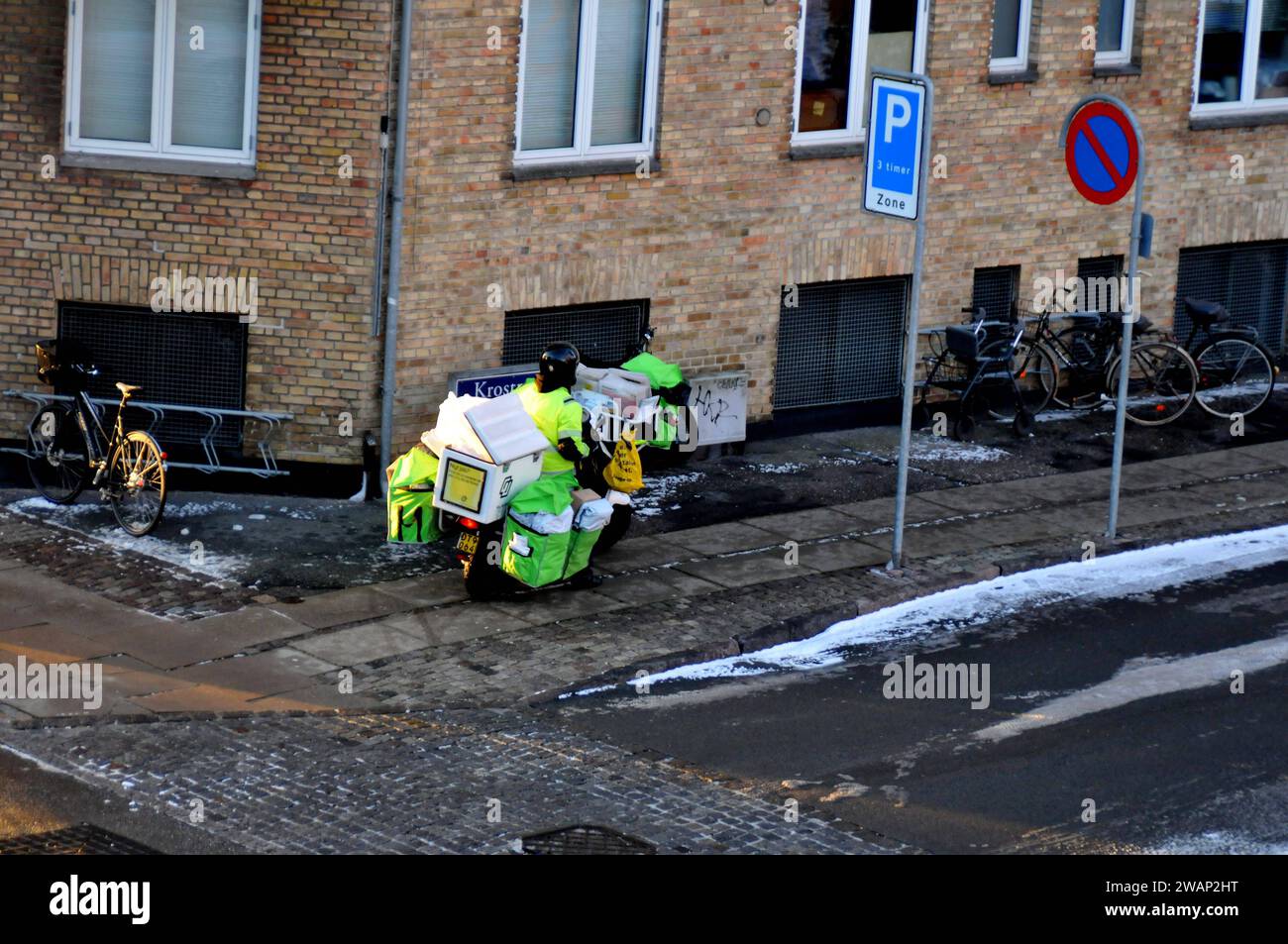 Kastrup/Copenhagen, Denmark/06 January 2024/Person deliver newspaprs n